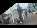young blond girl candid smoking at the bus stop