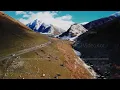 Drone captures vehicle navigating harsh wilderness with dramatic natural scenery
