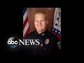 A police officer was shot and killed while in his squad car in Fayetteville Arkansas