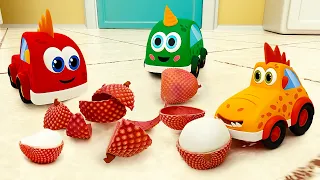 The cars and trucks were playing in the kitchen and found a new, unusual fruit.