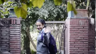 Locked-On Shot Of A Schoolgirl Going To School And Waving Hand - Stock Footage Hive 12882870