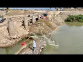 Good Operator Loader Pushing Soil Across Water Flowing Building Temporary Road
