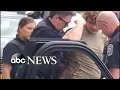 shows police arresting Buffalo mass shooting suspect