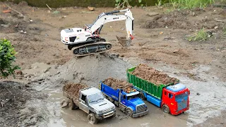 Excavator Loading Mud to 3 Dump Trucks in Deep Mud Road