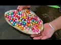Great harvest Girl hunts mussels in the lake and collects hundreds of perfect colorful pearls