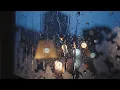 dark cozy cinematic shot of steady rain falling on a window pane