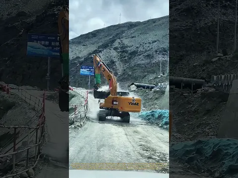 Bucket Shower: An Excavator Uses Its Own Scoop to Rinse Off the Mud