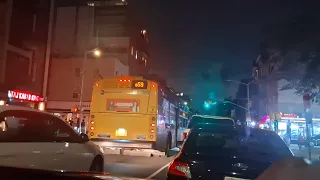 Mta bus Williamsburg Bridge Plaza and Rego Park bound Q59 buses NIS bus at Grand Avenue at night