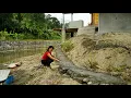 Lagu Foundation construction process using stone, preventing landslides and erosion.