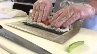 A sushi chef s demonstration of the technique for making a California roll