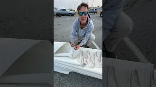 We flaked our mainsail on concrete today! Actually it was asphalt because we have no grass around…