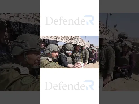 Netanyahu, surrounded by Israeli soldiers, watches the ruins of Gaza he destroyed.