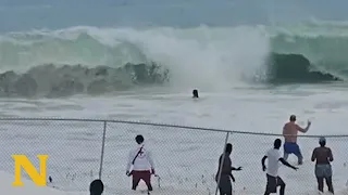 Drowning Victim Trapped Against Fence: Dramatic Ocean Rescue Caught on Camera