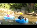 Well-dressed commuters brave the rapids of Boulder Creek on quirky Tube To Work Day