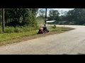 Man cuts grass after seeing students waiting at bus stop in dangerous conditions