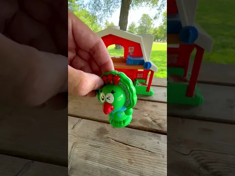 Giraffe Peacock And Lion Toys Settling Inside A Red Barn Outdoors