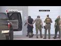 of mail bomb suspect in custody handcuffed