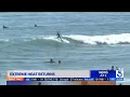 Beachgoers head to Huntington beach to beat the heat