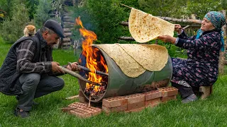 Traditional Lavash Bread Baking Bread On A Barrel Over Wood Fire 