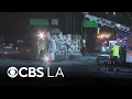 Overturned cement truck blocks several lanes on northbound 110 Freeway in Gardena