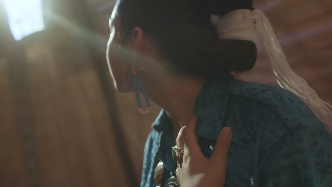 A woman wearing turquoise and sterling silver jewelry
