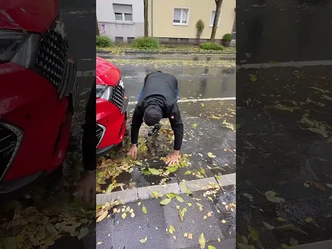 S#079-2 Unclogging a storm drain on a parking space during rain in Germany, #shorts