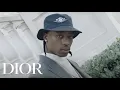 Travis Scott models the Air Dior line