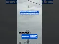 Helicopter Carries Worker To Power Transmission Tower