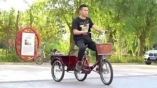 The three-wheel bicycle 24-inch adult tricycle with a rear cargo basket