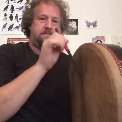 Celtic musician playing a bodhran.