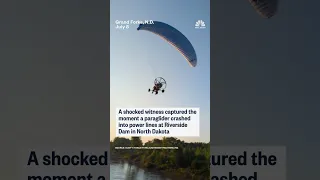 A shocked witness captured the moment a paraglider crashed into power lines in North Dakota