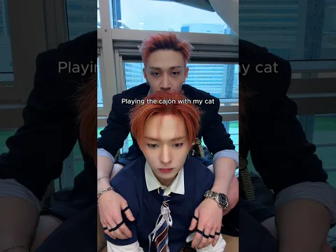 Bang Chan playing cajón with his cat (Lee Know)