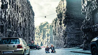 couple wakes up to find all buildings surrounded by a mysterious brick wall