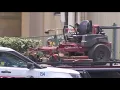 Riding mower flips lands on top of driver on West Side