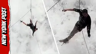 Tourist Left Dangling From Rope as Waterfall Continuously Crashes Over Him