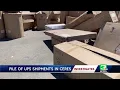 Pile of UPS packages left in parking lot for weeks