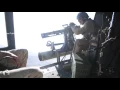 UH-1Y Huey Marine Crew Chief fires GAU - minigun from archival footage