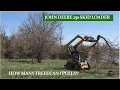 John Deere 250 Skid Loader Pulling Trees from the Earth