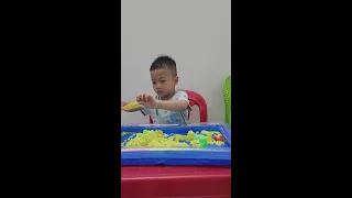 Baby Tom playing sand