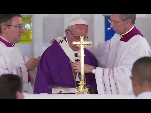 Mons. Marini helping the Holy Father change the ve...