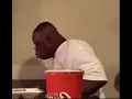 Man falls out chair while eating canes chicken