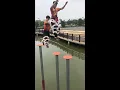 Lagu Dancers practice traditional Chinese lion dance on poles in water