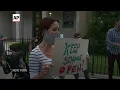 Parents protest school closures in virus spike areas