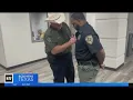shows Ellis County Sheriff Brad Norman cutting patch off fired deputy