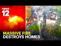Massive fire rips through homes displacing 11 residents