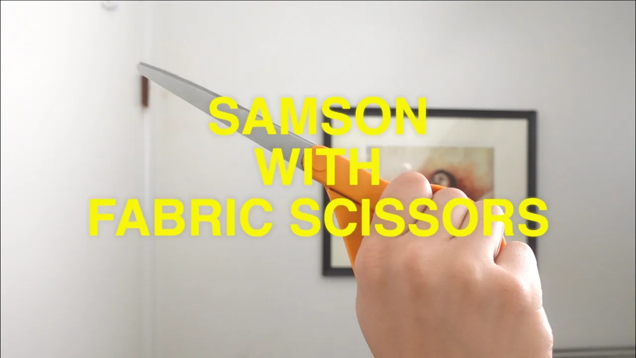 SAMSON WITH FABRIC SCISSORS:  Giving myself a quarantine haircut with zero training.
