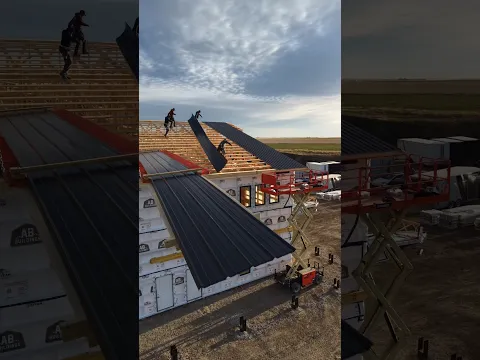 Unwrapping and installing these nice 48 foot long @MetalWholesale roof sheets on the new building!