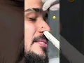 Man is all smiles while getting his nose and ear pierced