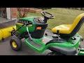 A snaw plow is attached to John Deere D140