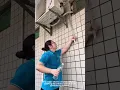 Download Lagu Woman Cleans AC Outdoor Unit for Better Cooling